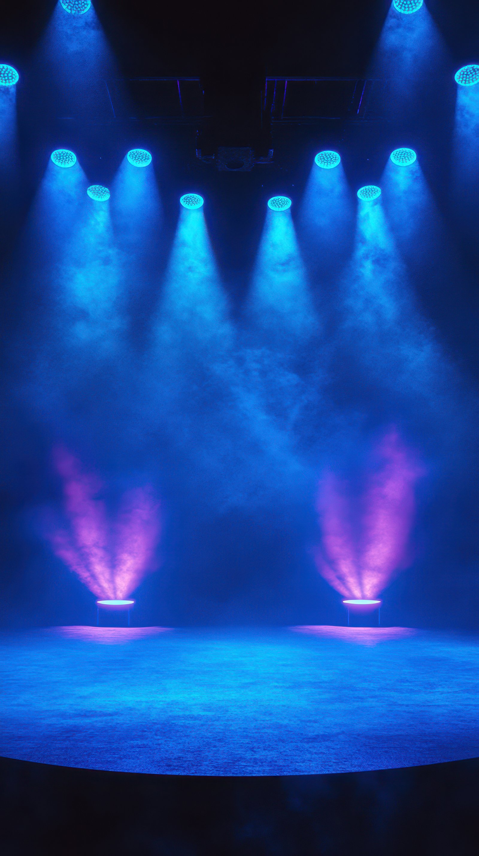 Dynamic stage lighting with blue and purple hues creates an atmospheric backdrop for a performance setting in a theater